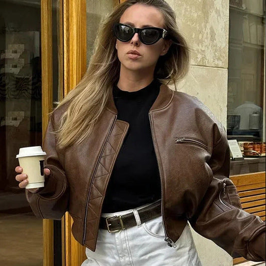 Black faux leather bomber jacket with elastic cuffs, side pockets and sleeve zip pocket