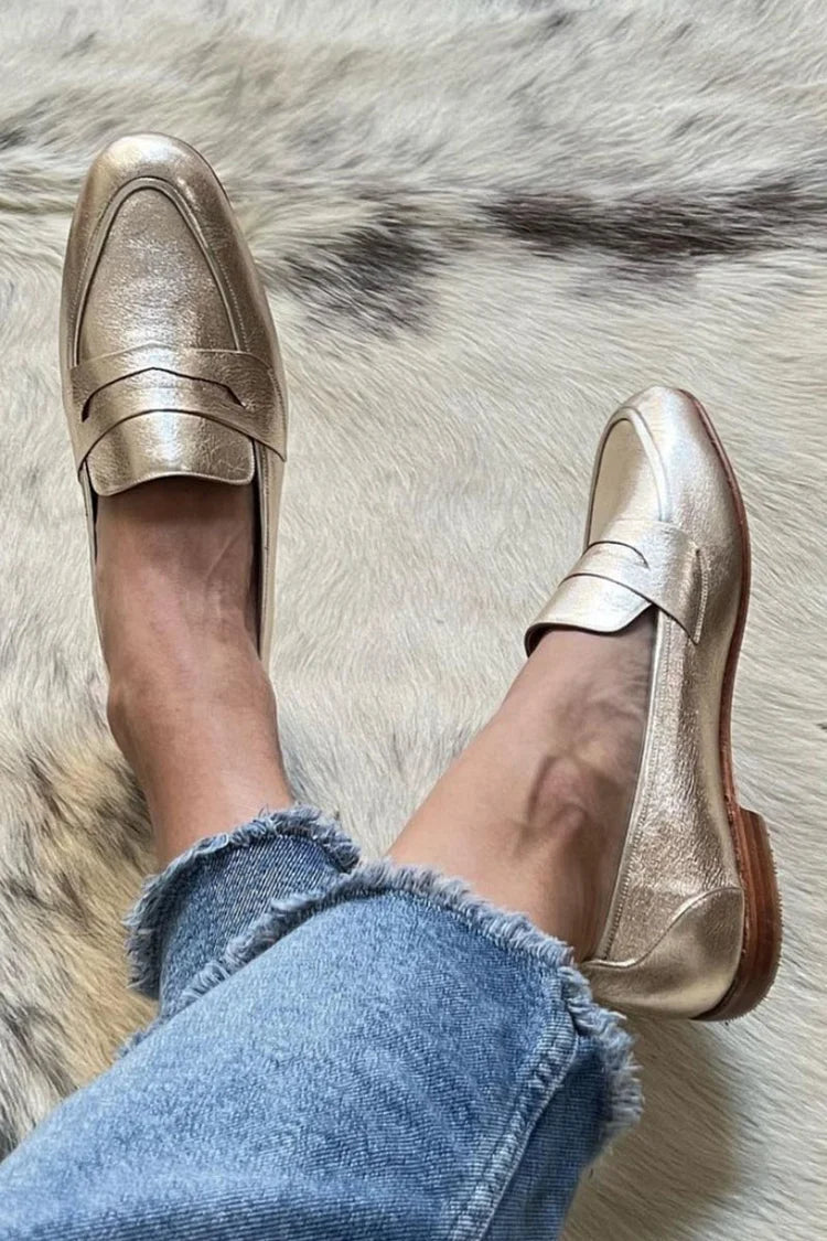 Gold metallic leather loafers with a slip on vamp and structured toe