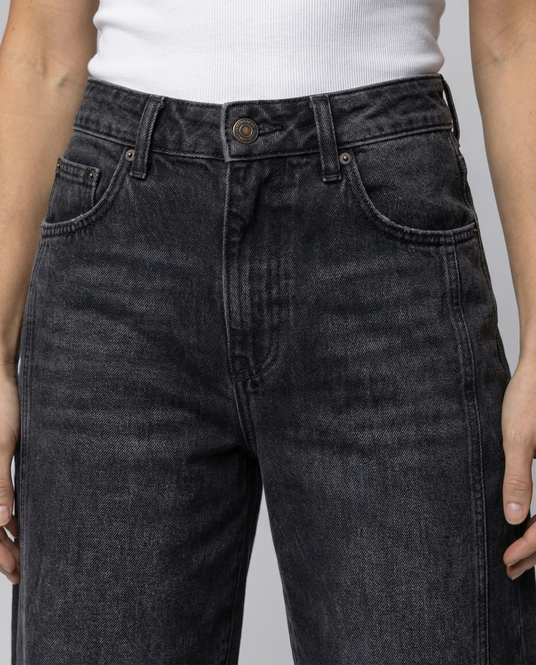 Blue barrel leg jeans with a mid rise waist and rounded slightly flared leg