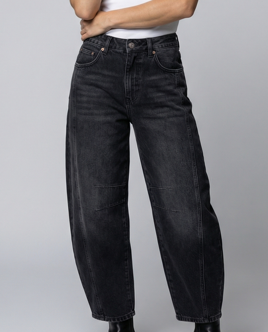 Blue barrel leg jeans with a mid rise waist and rounded slightly flared leg