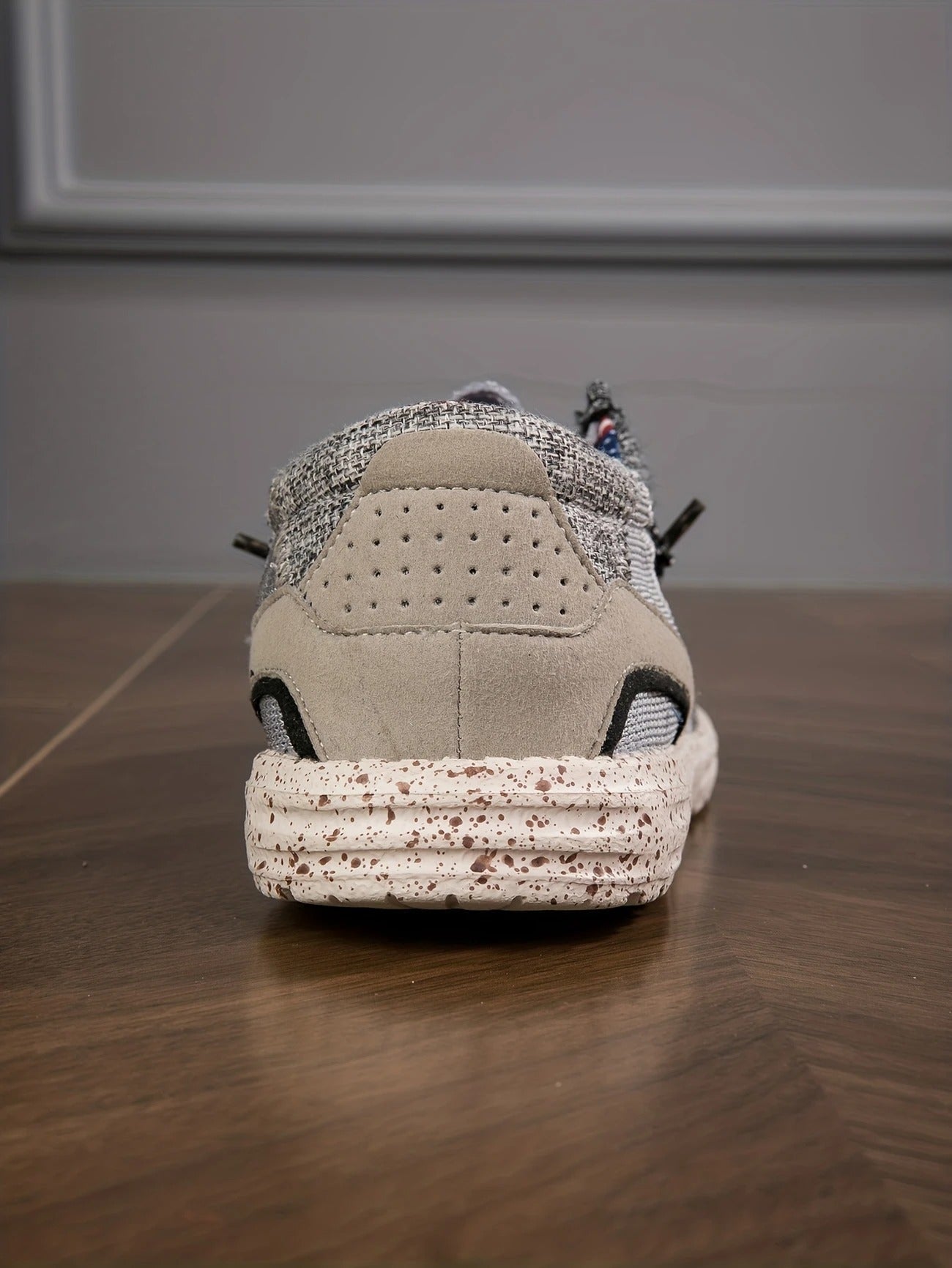 Beige canvas slip on loafers with a speckled rubber sole and a padded collar