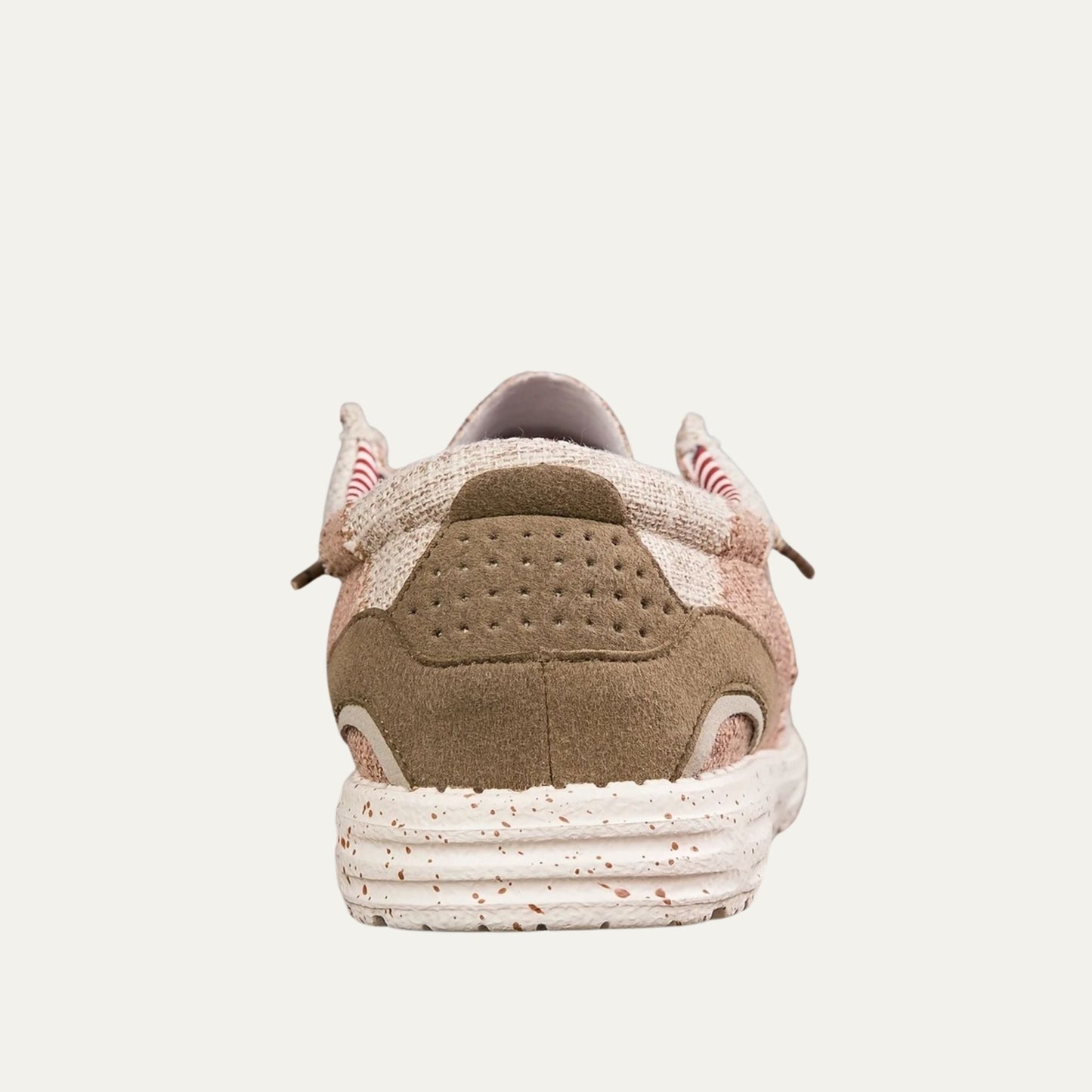 Beige canvas slip on loafers with a speckled rubber sole and a padded collar