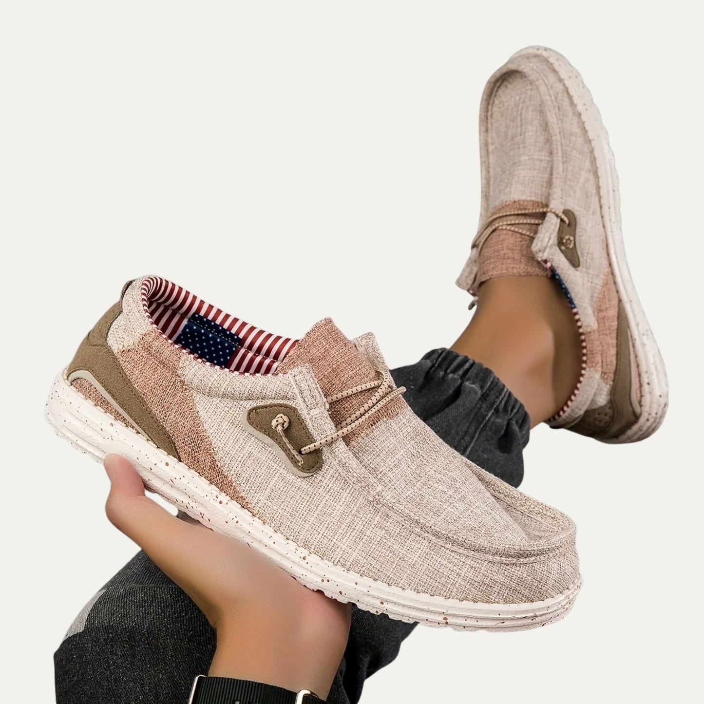 Beige canvas slip on loafers with a speckled rubber sole and a padded collar