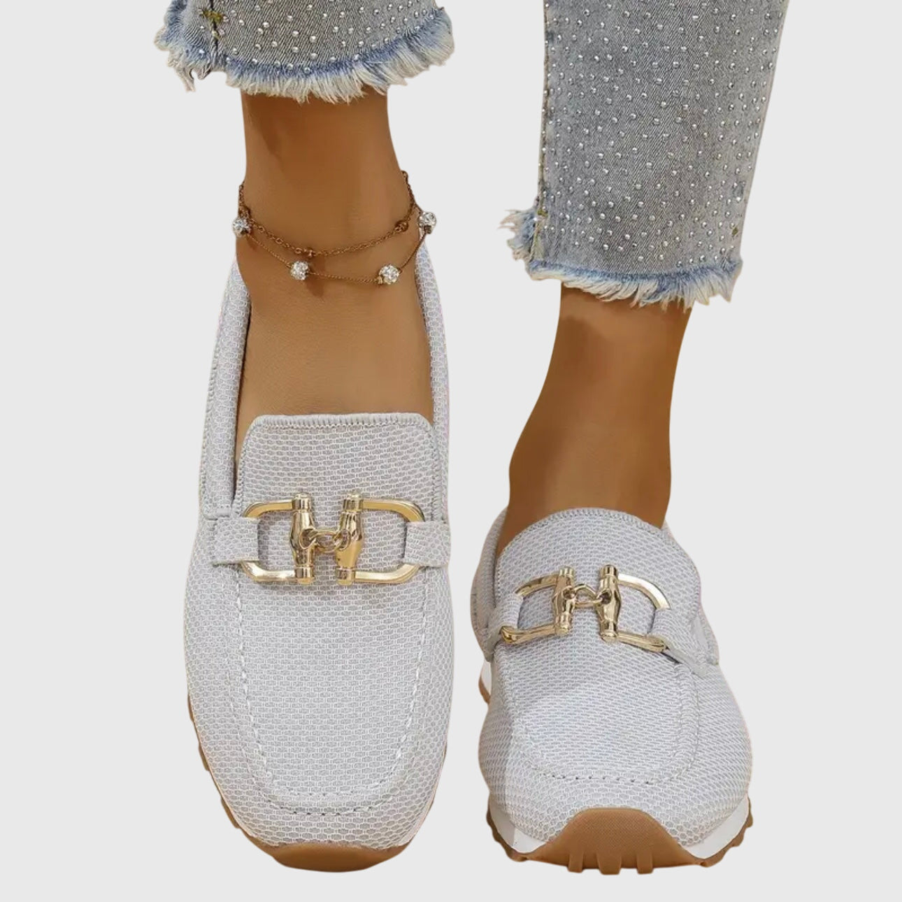 Beige casual slip on loafers with a textured upper and small front hardware detail