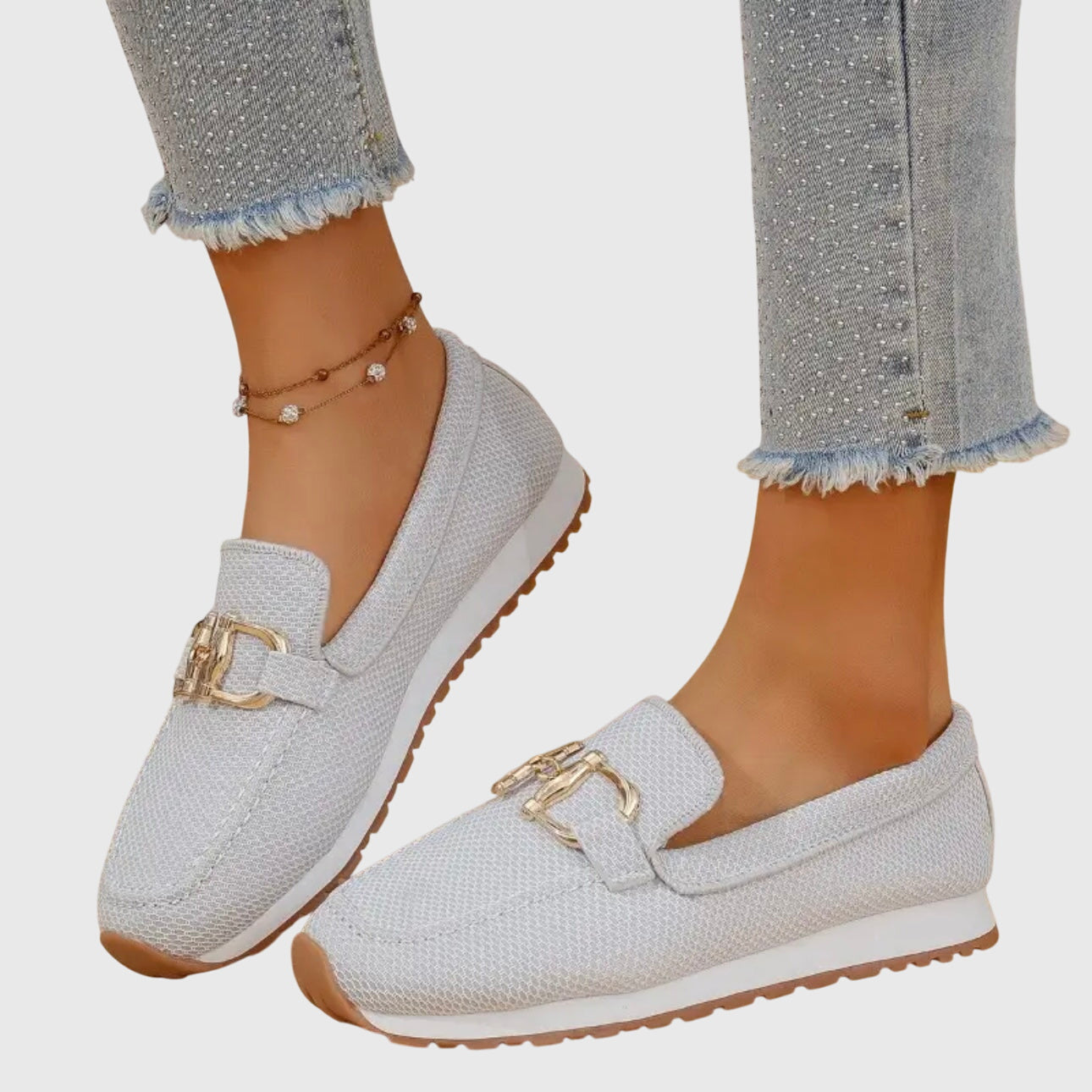 Beige casual slip on loafers with a textured upper and small front hardware detail
