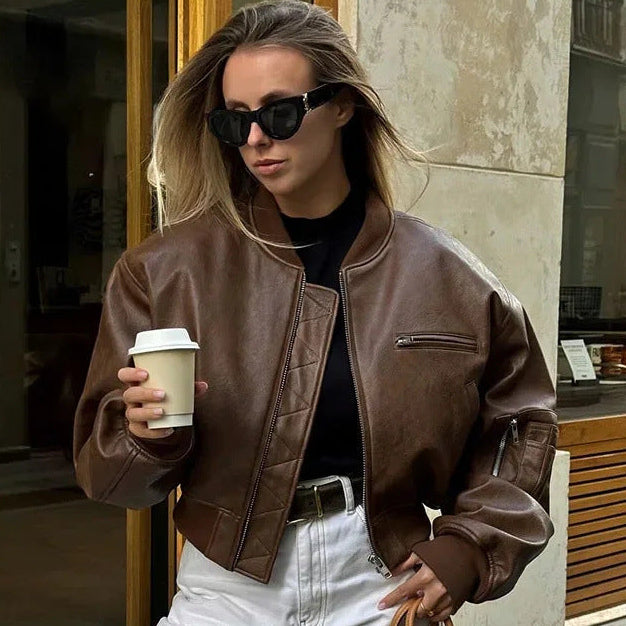 Black faux leather bomber jacket with elastic cuffs, side pockets and sleeve zip pocket