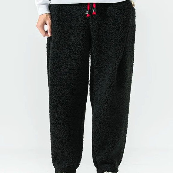 Men's relaxed fleece joggers in brown with a textured surface and drawstring waist