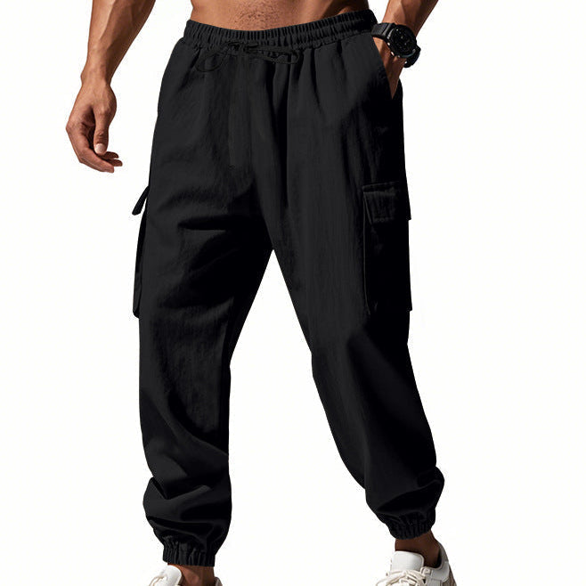 Men's tapered utility joggers in black with flap thigh pockets and elasticated cuffs