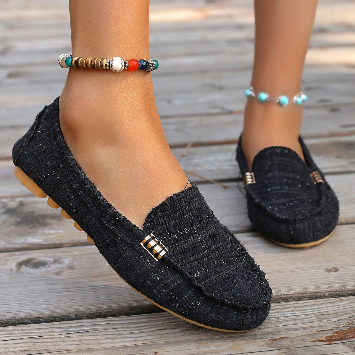 Brown leopard print moccasin loafers with decorative stitching and a studded sole