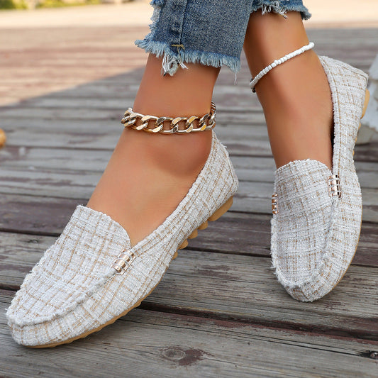 Brown leopard print moccasin loafers with decorative stitching and a studded sole