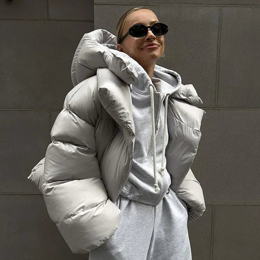 Grey oversized cropped puffer jacket with a deep padded collar and quilted shell