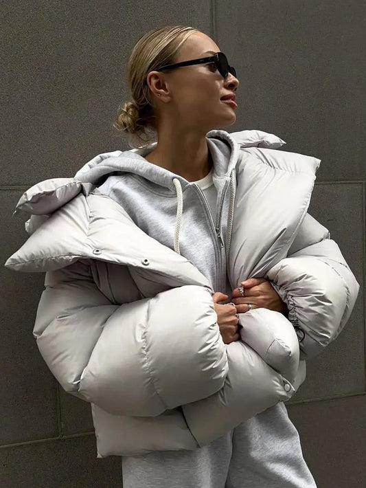 Grey oversized cropped puffer jacket with a deep padded collar and quilted shell