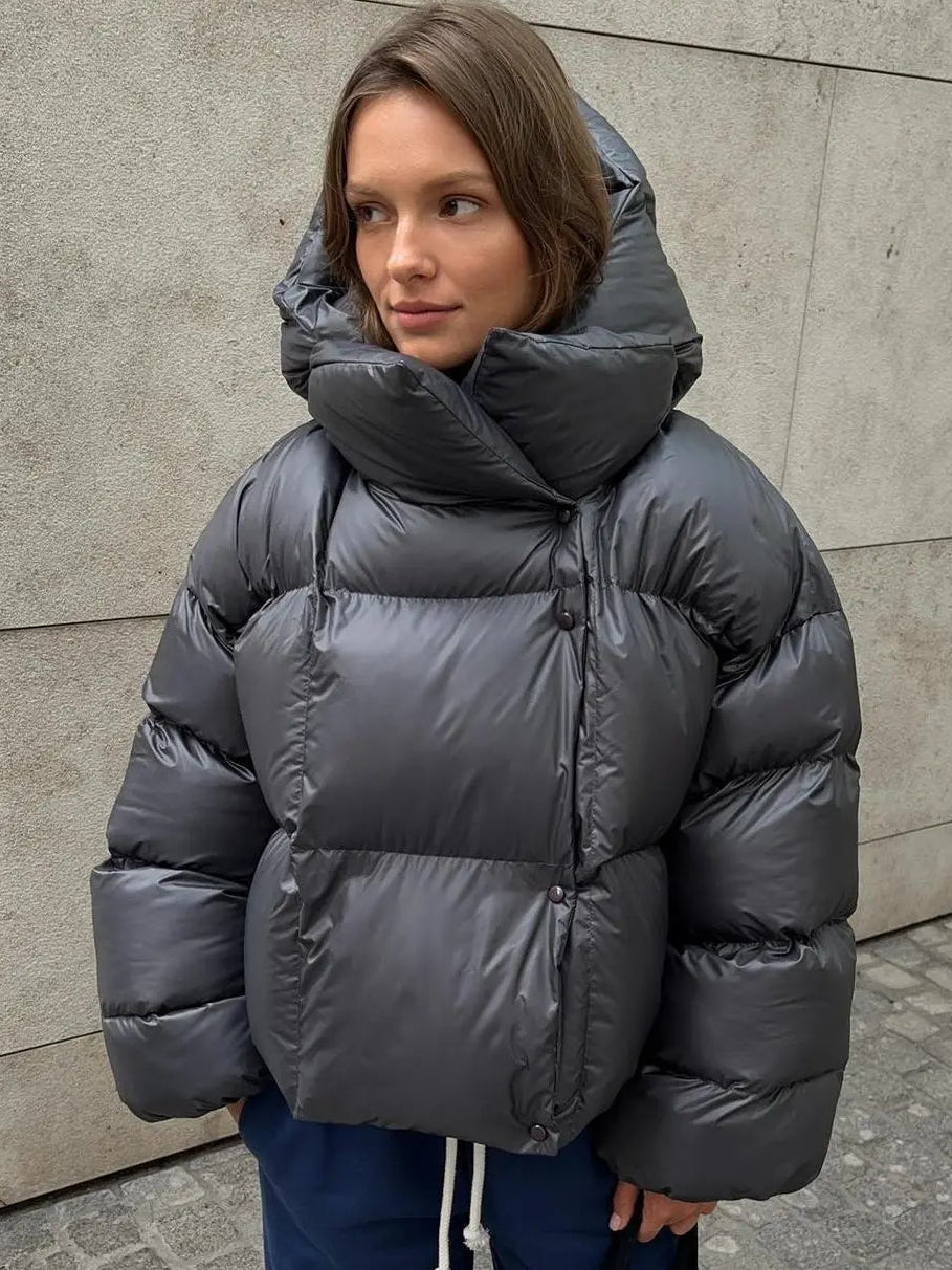 Grey oversized cropped puffer jacket with a deep padded collar and quilted shell