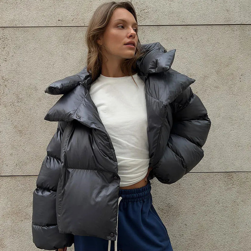 Grey oversized cropped puffer jacket with a deep padded collar and quilted shell