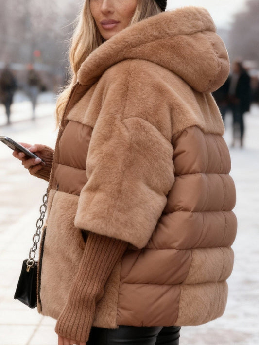 Brown oversized hooded puffer jacket with faux fur panels and a quilted padded body