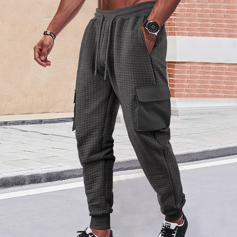 Men's light grey quilted cargo joggers with waffle texture and patch flap pockets