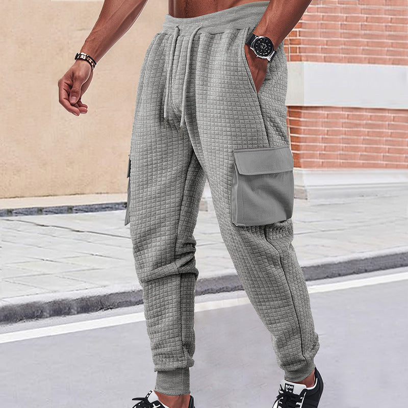 Men's light grey quilted cargo joggers with waffle texture and patch flap pockets
